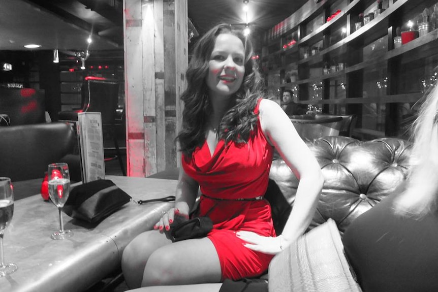 A Facebook photo of Kelly Brewster wearing a red dress.