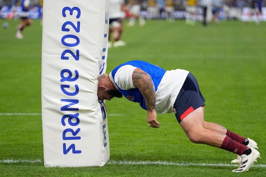 Joe Marler leans against a post