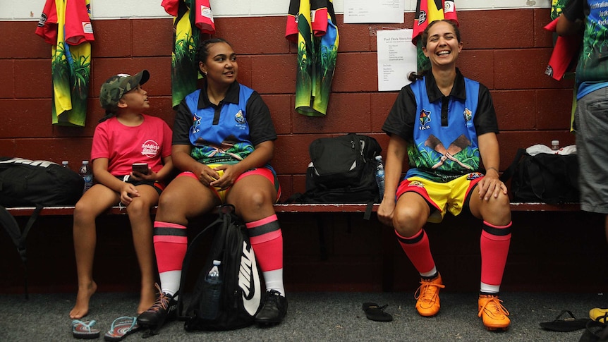 women in a locker room in sports gear