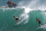 Two Surfers ride a large wave at Kirra on the Gold Coast.