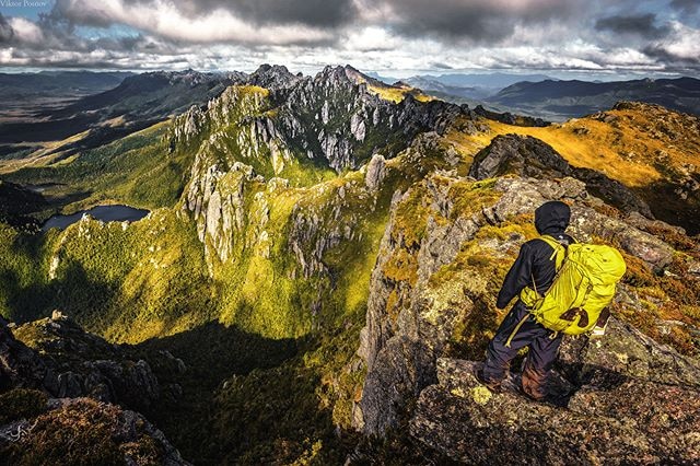 A bushwalker stands on Mount Hesperus.