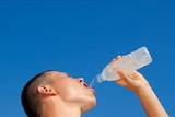 Young male athlete drinking