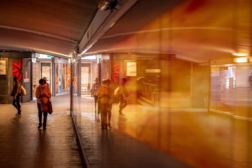 A pic of people wearing masks with a reflection.