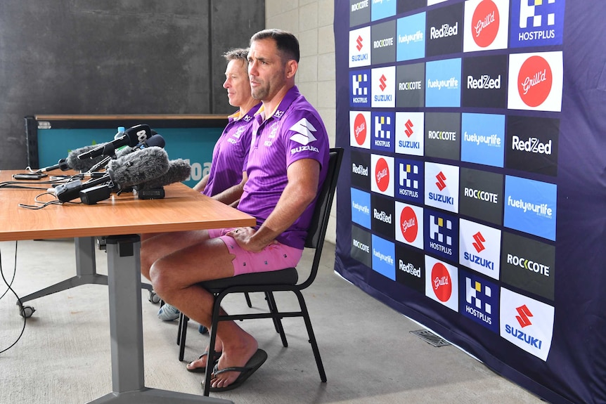 Melbourne Storm coach Craig Bellamy and captain Cameron Smith, wearing thongs, at a press conference before the NRL grand final.