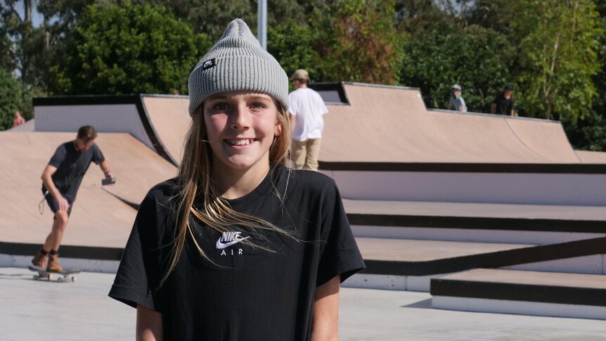 girl with beanie standing in skate park