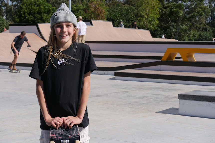 girl with beanie standing in skate park