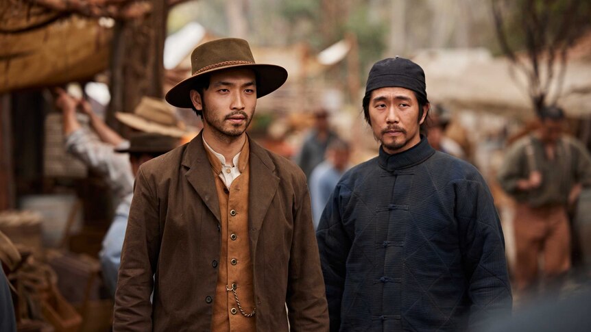 Two actors in period costume in the Chinese Camp set for the series New Gold Mountain.