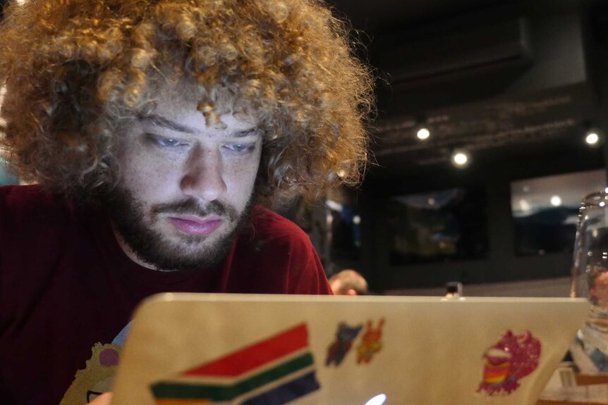 Russian journalist Ilya Varlamov looking at his laptop screen.