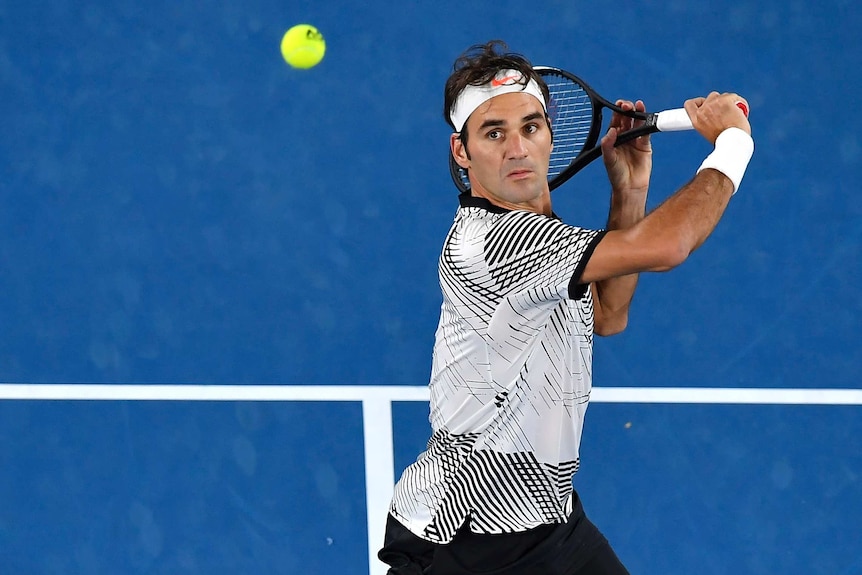 Roger Federer sets up for a backhand volley