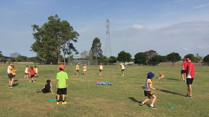 Kids practice football in a suburb of Logan.