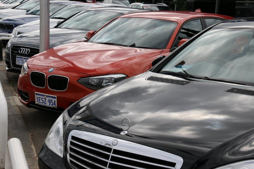 A row of luxury cars in a car sale yard.