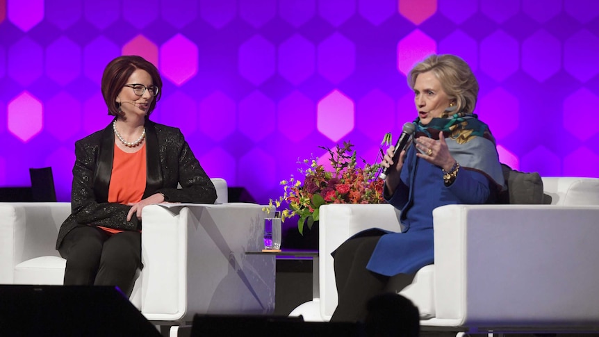 Hillary Clinton speaks with Julia Gillard on stage