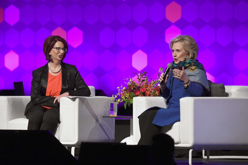 Hillary Clinton speaks with Julia Gillard on stage