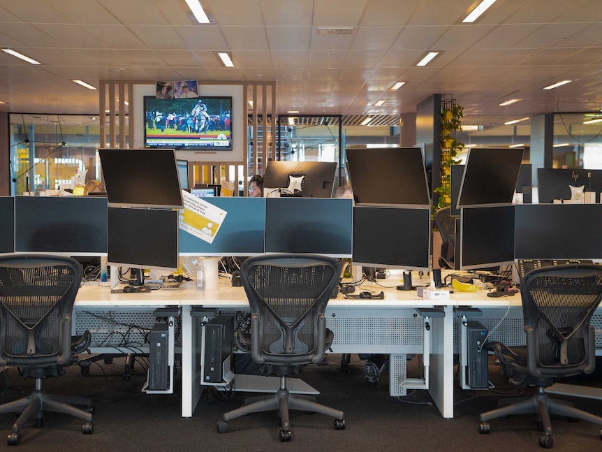Empty desks on the CommSec trading floor, including social distancing signs