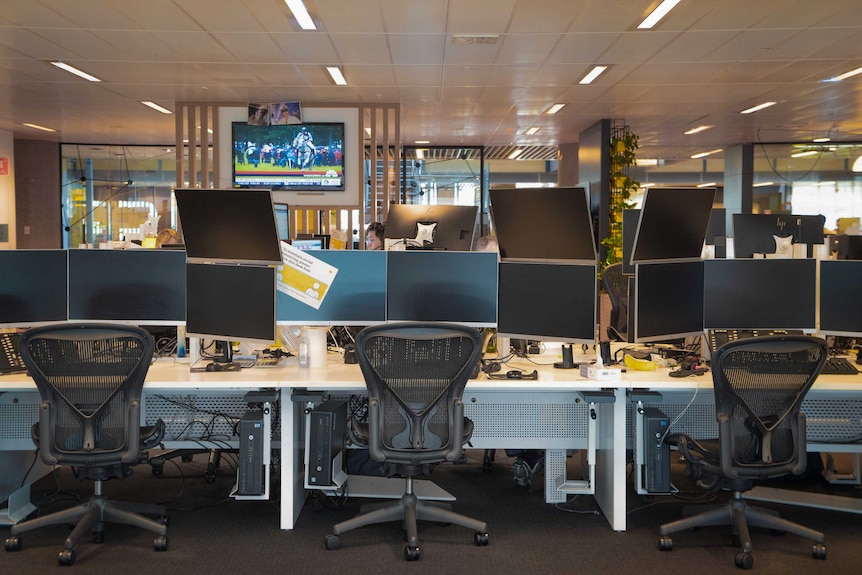 Empty desks on the CommSec trading floor, including social distancing signs