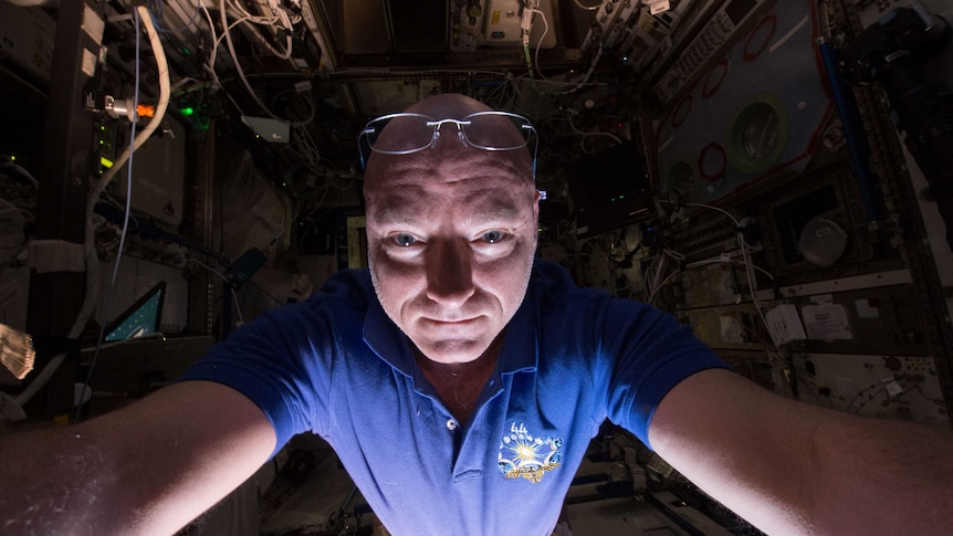 A NASA astronaut looks into the camera in a selfie in the International Space Station