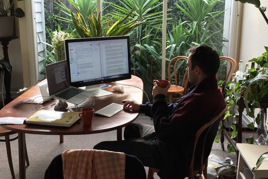 A photo of mental health advocate and Big Feels Club organiser Graham Panther sitting at his desktop computer.