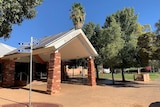 The brick exterior of the Alice Springs Town Council is seen on a sunny day.