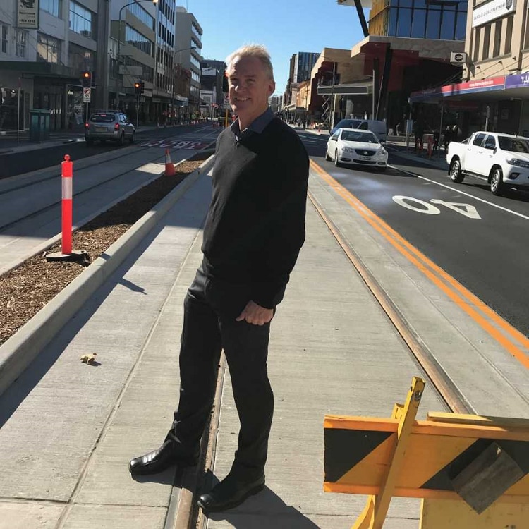 Bob Hawes standing on  Hunter Street light rail tracks in the Newcastle CBD