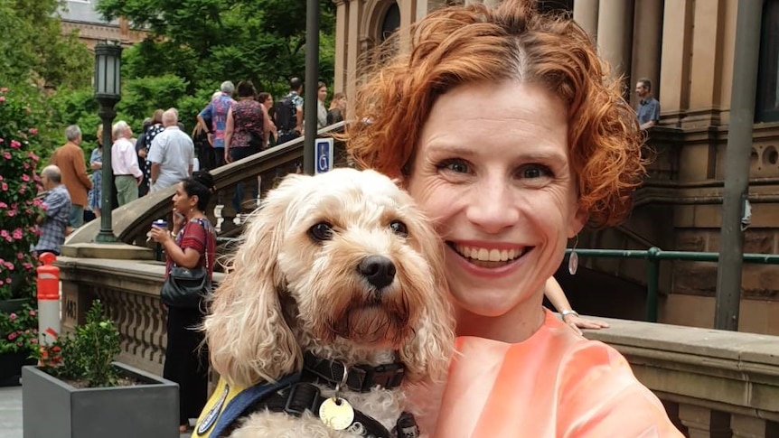 Author Fiona Wright with her dog in her arms.
