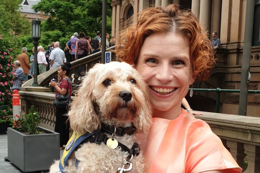 Author Fiona Wright with her dog in her arms.