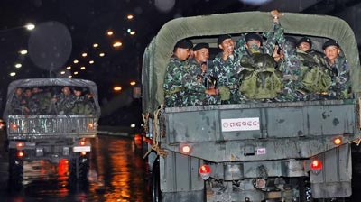Army trucks carry soldiers to take positions at the government installations in Bangkok.