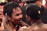 Floyd Mayweather Jr embraces Manny Pacquiao after their fight