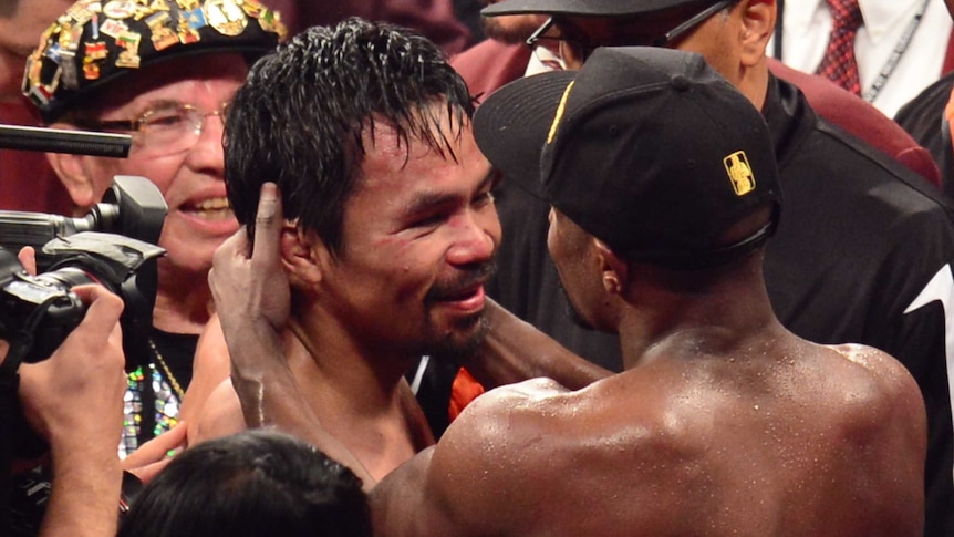 Floyd Mayweather Jr embraces Manny Pacquiao after their fight