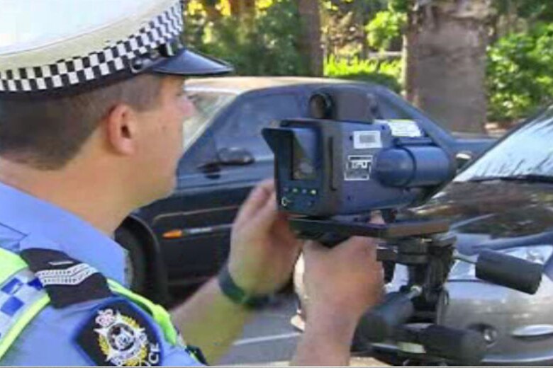 Generic photo of police officer with speed camera