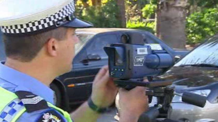 Generic photo of police officer with speed camera