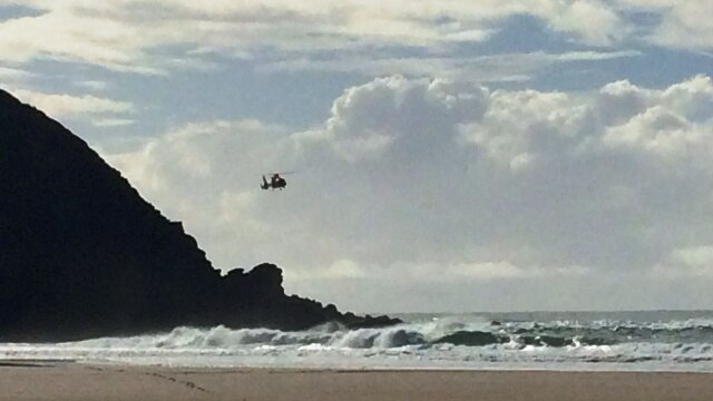 Rescue helicopter searches for missing surfer at Cape Byron