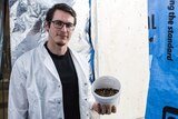 Martin Pike, 29-year-old CSO of Karma holding a container filled with Black Soldier Fly larvae.