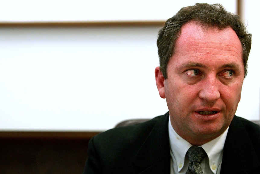 A young Barnaby Joyce looks sideways. He is wearing a suit