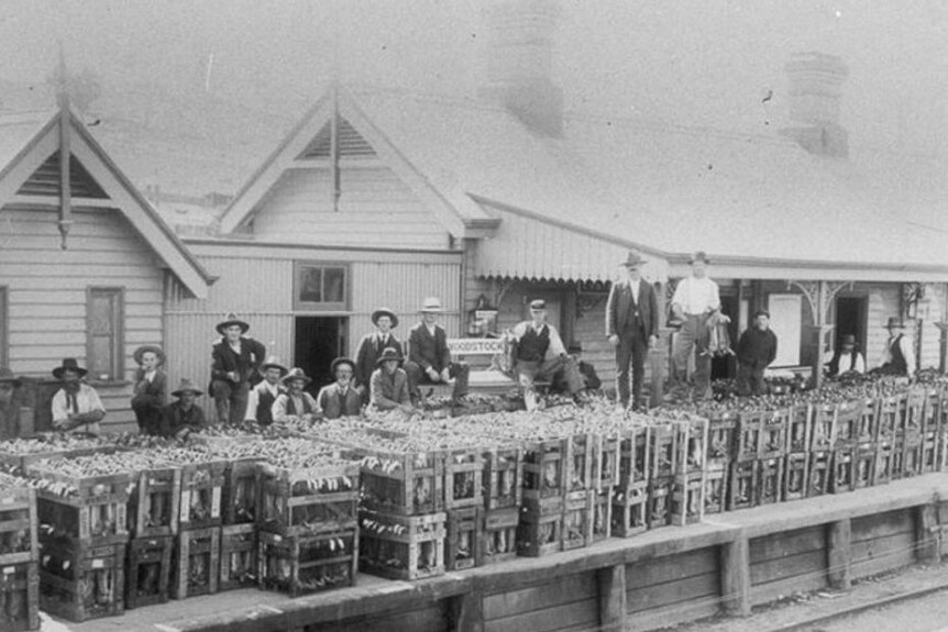 An archival photo showing men on a railway platform.