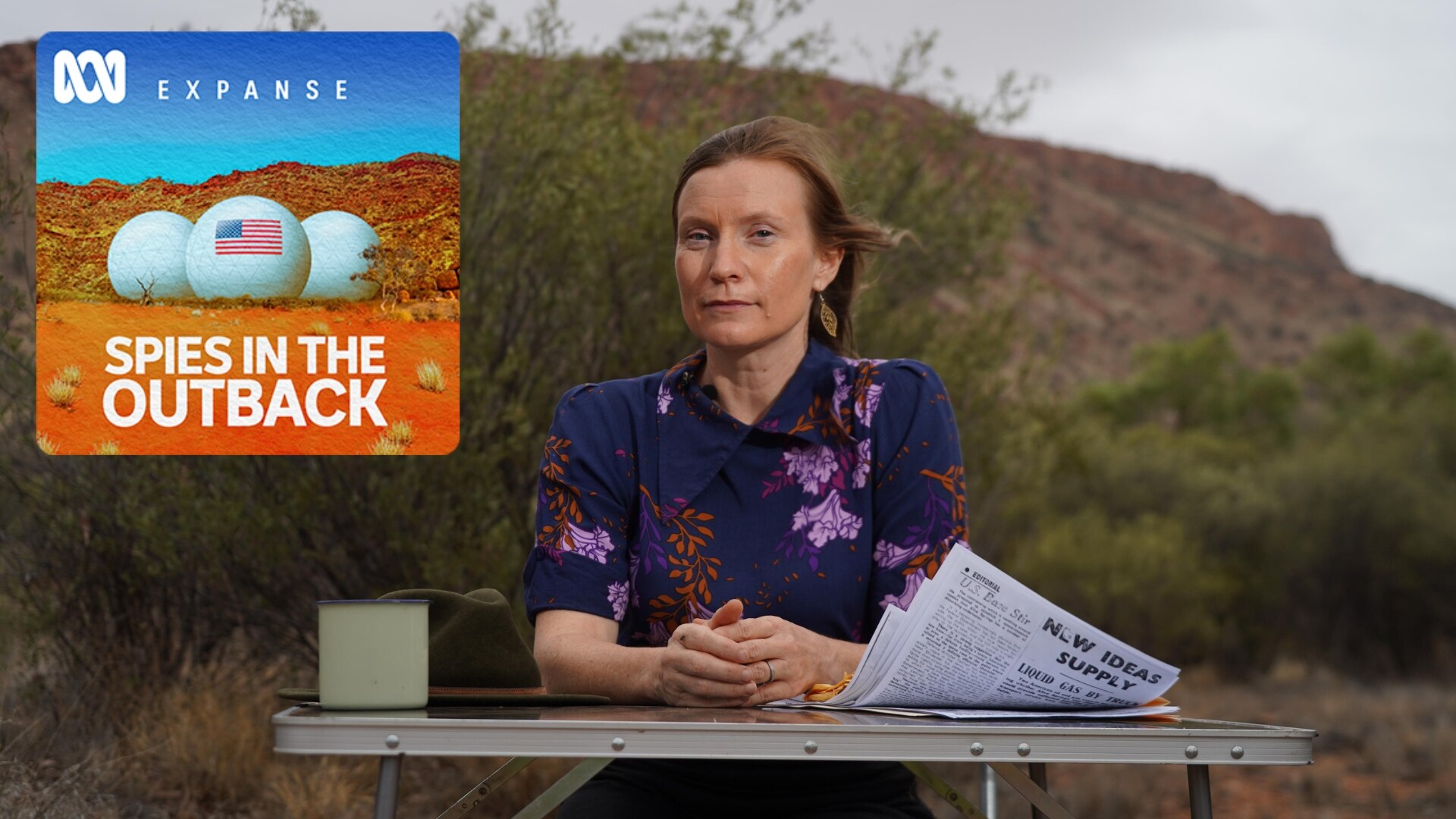 Alice Springs journalist Alex Barwick at desk with outback background and Spies in the Outback podcast tile