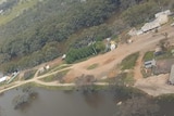 An aerial view of a township surrounded by flood water.