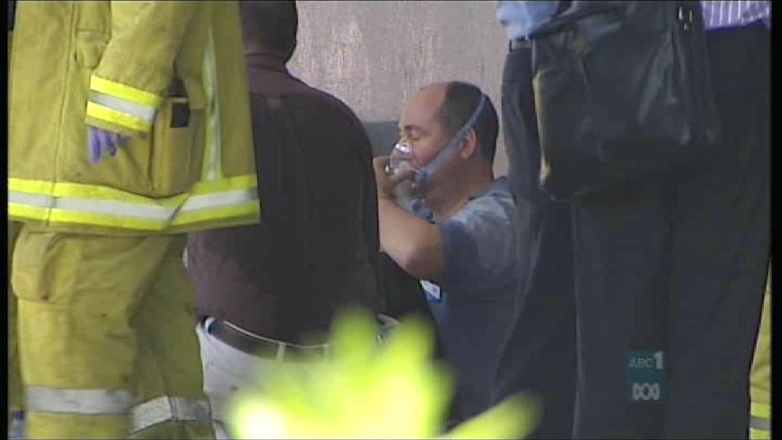 A man is treated after yesterday's fire attack on Darwin's TIO office.