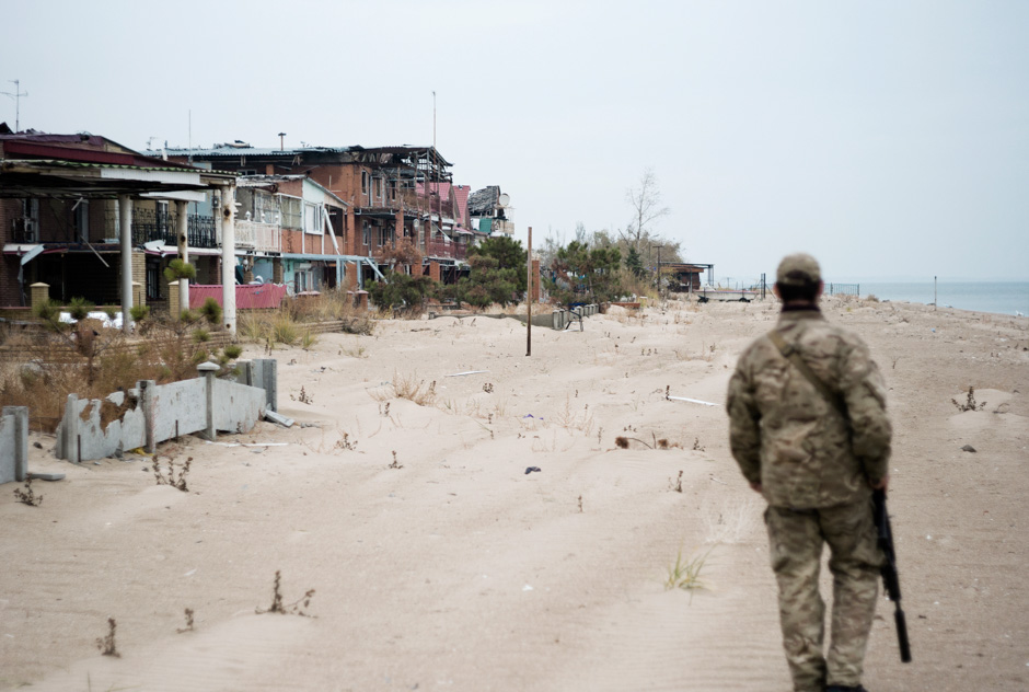 A Marine patrols along once popular beaches of Shirokino, five kilometres from Mariupol.
