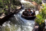 A group of people go down the fake river on the Thunder River Rapids Ride.