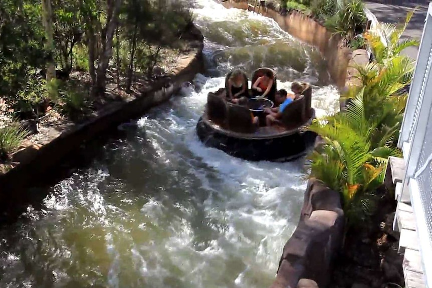 A group of people go down the fake river on the Thunder River Rapids Ride.