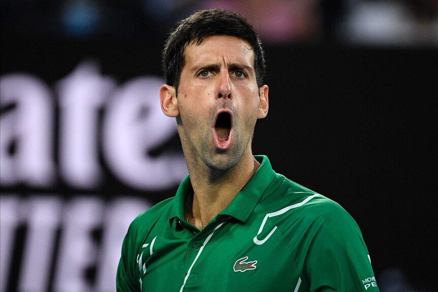 A tennis player roars with is mouth wide open during a big final.