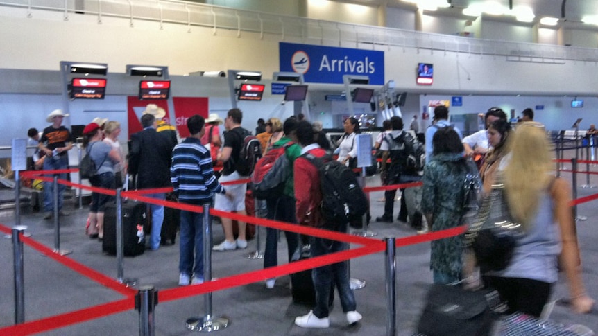 Passengers line up for a flight