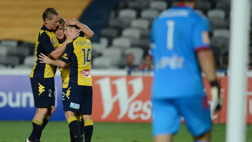 The Mariners' Daniel McBreen, Nick Fitzgerald and Michael McGlinchey celebrate against Adelaide.