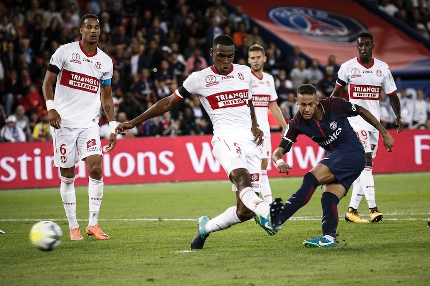 Neymar gets a shot away as four defenders look on helplessly.