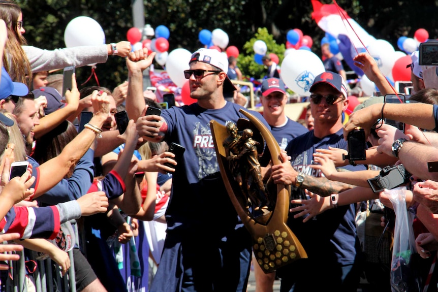 Sydney Roosters captains Boyd Cordner and and Jake Friend walk in with the Provan-Summons Trophy.  