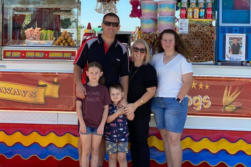 Jesse McDonald and family standing outside their food stall set up on Blunder Road, Doolandella.