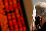 A man talks on his mobile phone at the Australian Stock Exchange