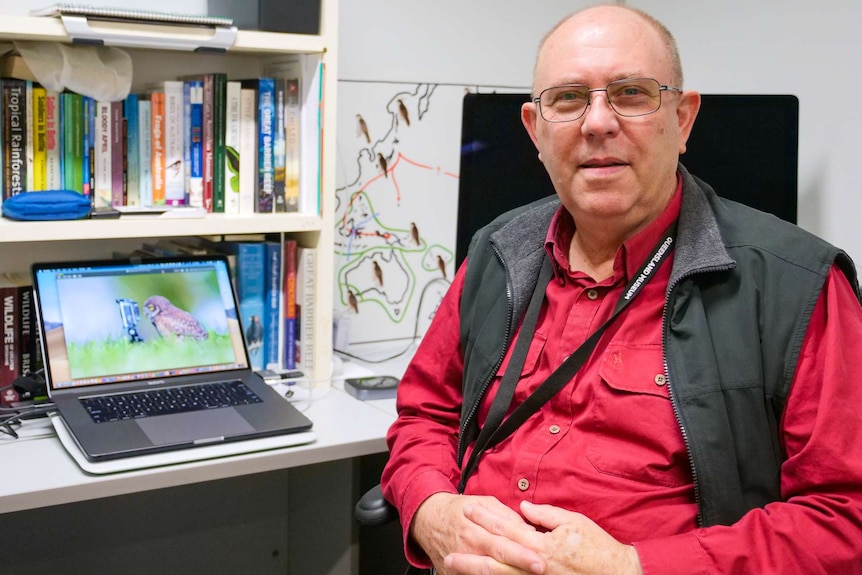 Man sitting at a desk with a computer.