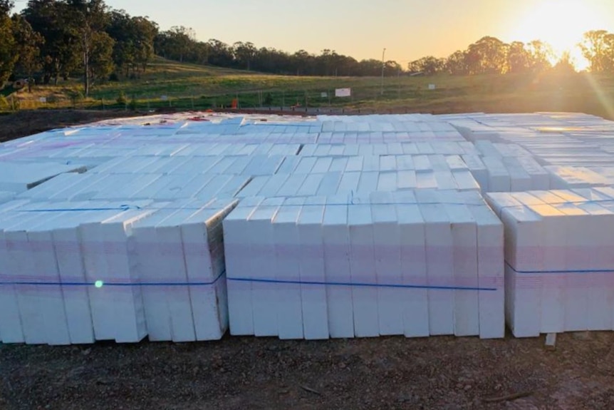 A large slab of waffle pods as the sun sets in the back ground
