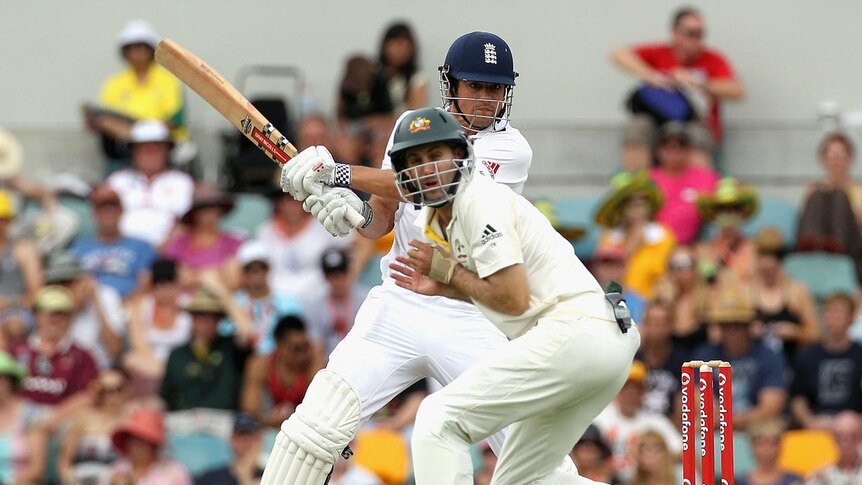 Dishing out the pain... England centurion Alastair Cook hits the ball into Australia's Simon Katich on day four at the Gabba.